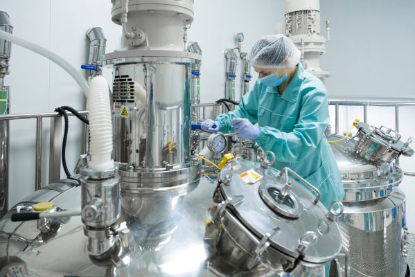 Pharmaceutical technician in sterile environment at pharmacy industry